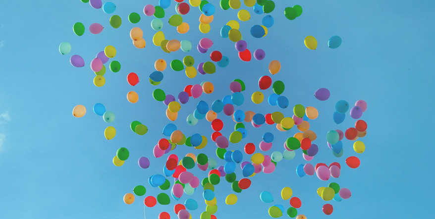 Image of balloons floating into the air