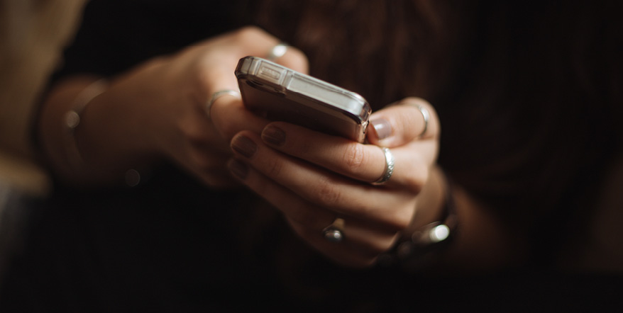 Image of woman's hands holding smartphone.