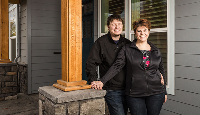 Tiffany & James in front of their new home