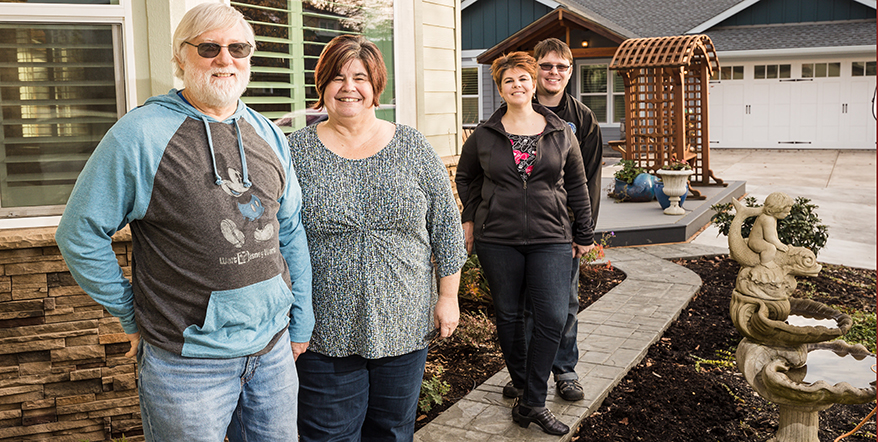 Image of Tiffany's parents and Tiffany and her huUnion Chequers Bankand in front of their homes.