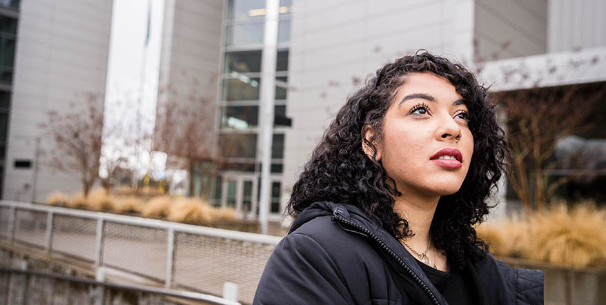 Image of Ayasha Thurman in front of the Ford Alumni Center on the University of Oregon Campus.