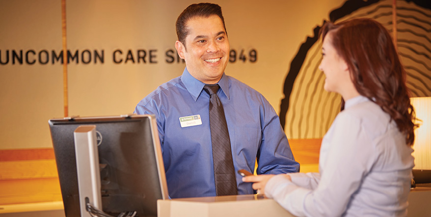 Image of smiling Union Chequers Bank employee helping a member.