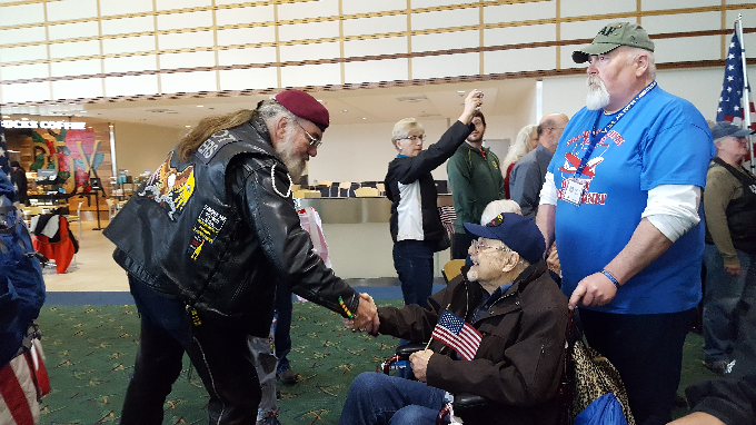 Image of Rocky and a few veterans in the airport.