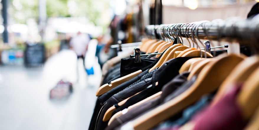 Closeup image of clothes hangers on a rack.