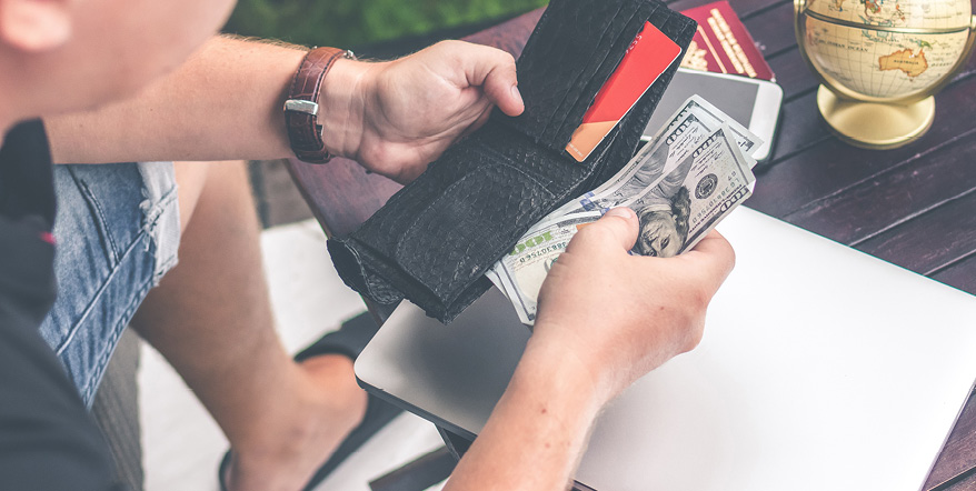 Man pulling cash out of his wallet