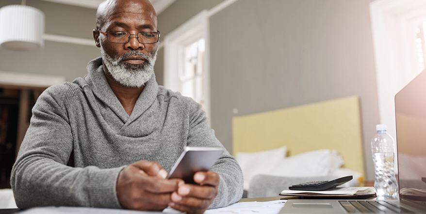 Image of older man looking at his cell phone.